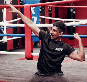 Coach Kumar flexing biceps like Superman