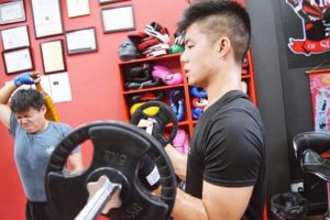 Gym members engaged in weight training and lifting weights