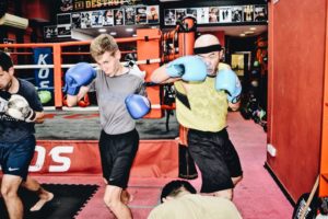 Students immersed in intense shadow boxing practice, giving it their all.