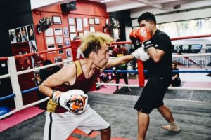 oxer throwing a punch while opponent skillfully defends.