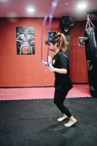 Side view of a person jumping rope with precision