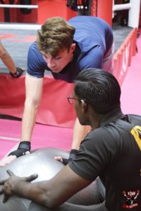 Coach Krishna providing expert guidance during a push-up workout session.
