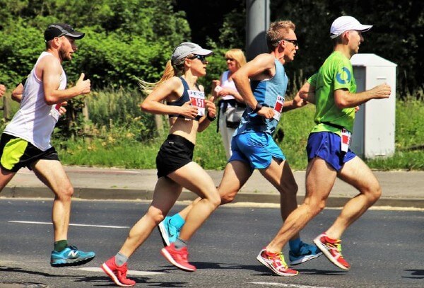 A group of marathon runners racing together in unity